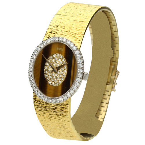18ct yellow gold, reference  9826 oval cased bracelet watch with tigers eye dial. Made 1970's